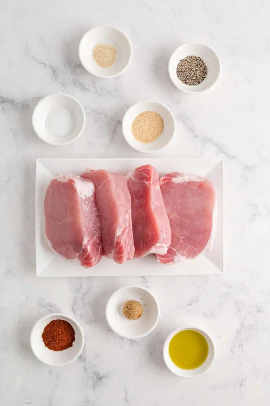 Overhead view of ingredients including uncooked pork chops.