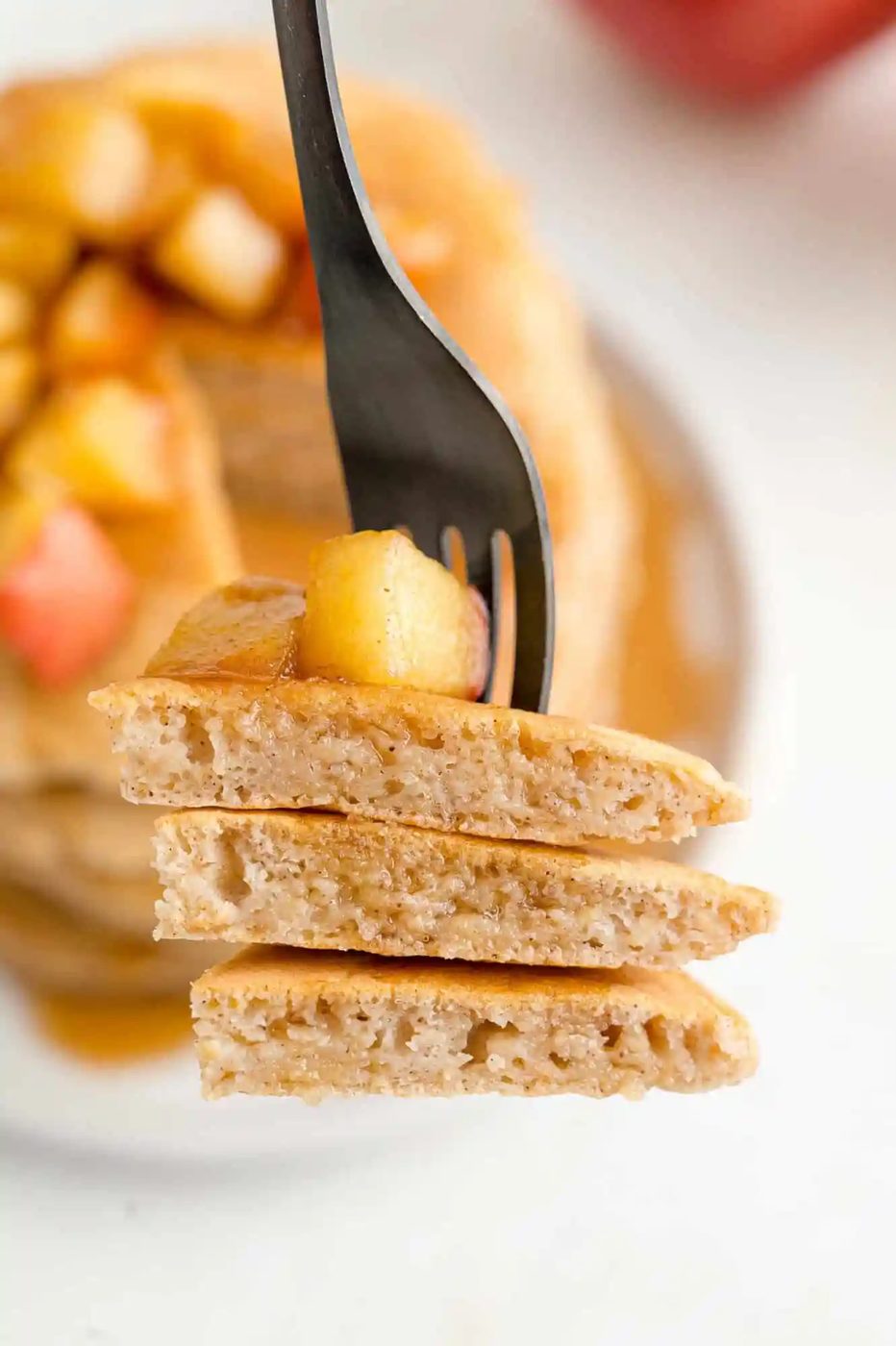 Apple pancakes, cut on fork to show texture.