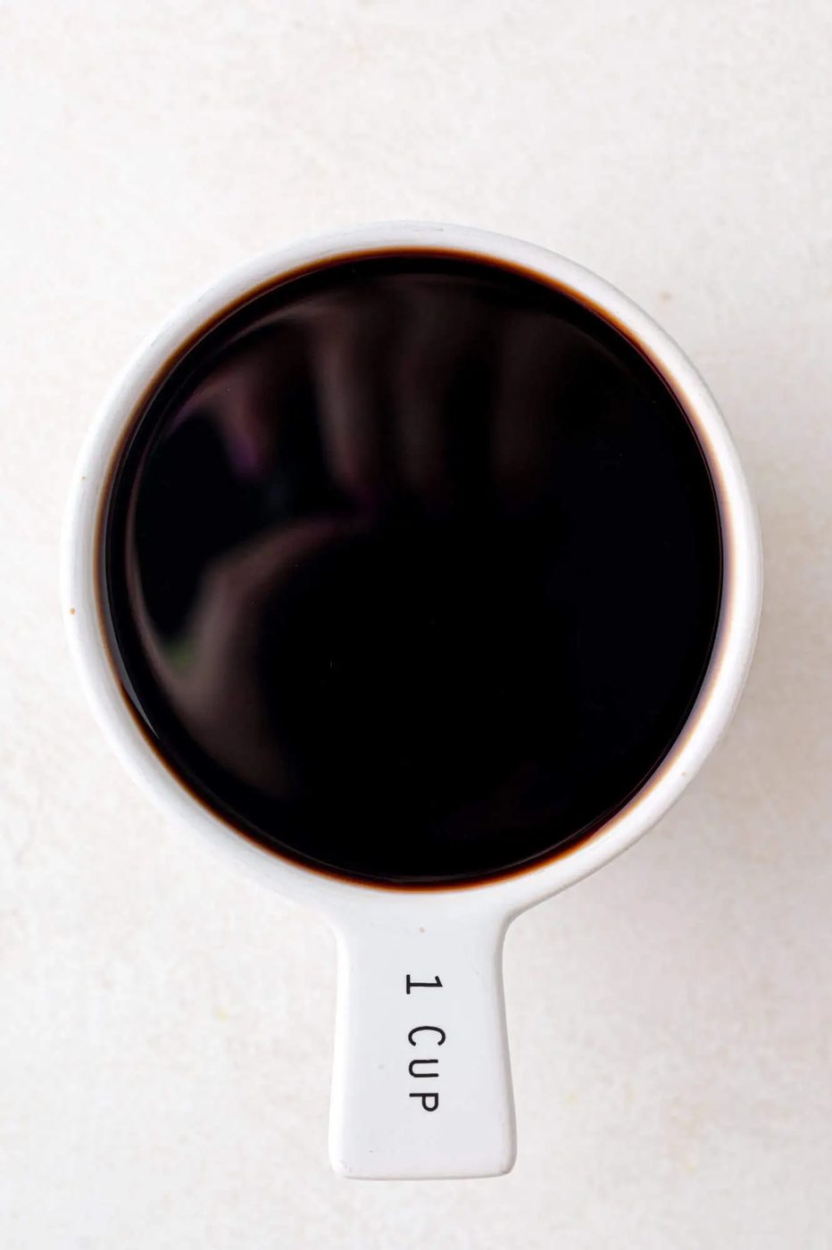 Balsamic vinegar measured into a 1 cup measuring cup.