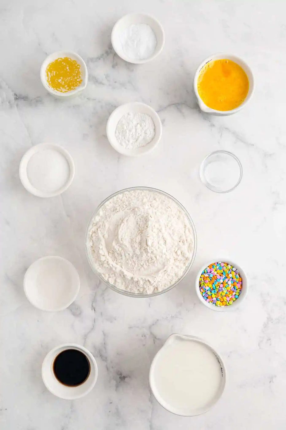 Overhead view of ingredients needed for birthday cake pancakes.