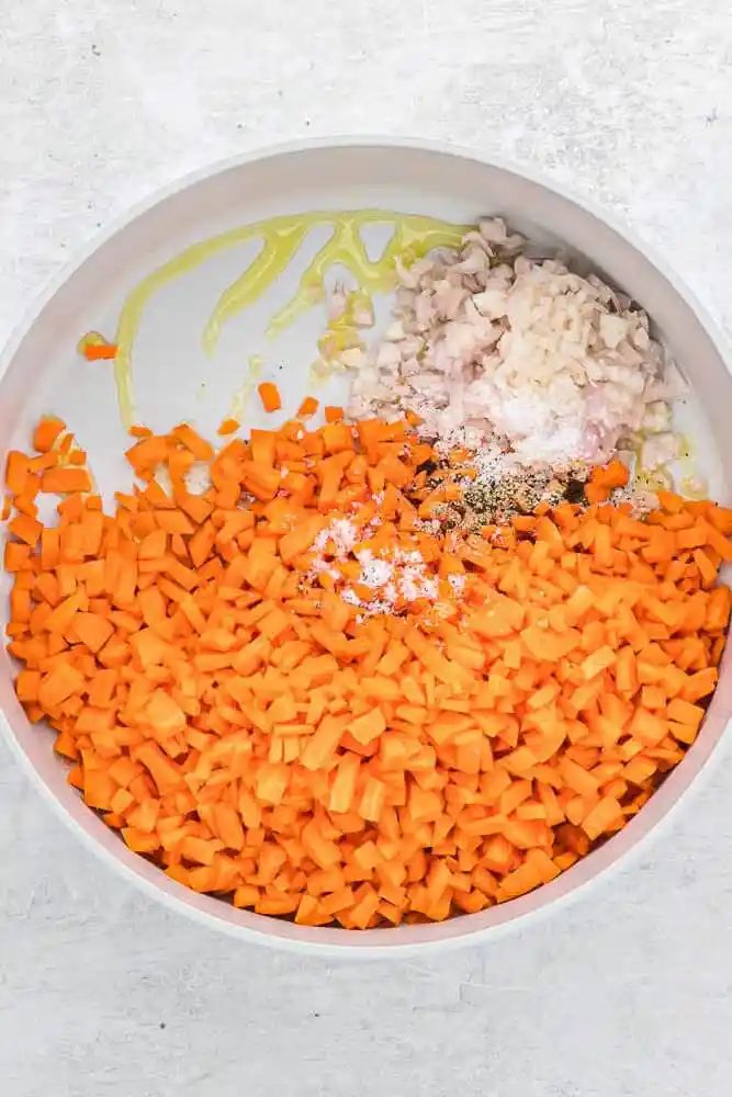 Carrots and shallots in a saute pan.