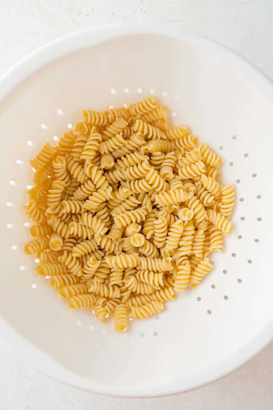 Drained rotini pasta still in colander.