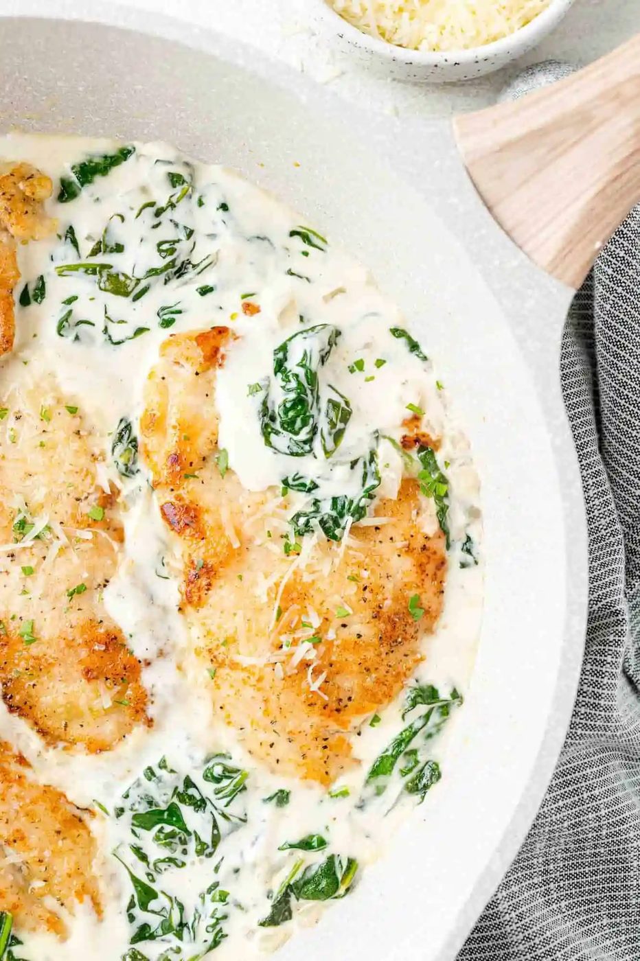 Chicken Florentine in a white skillet.