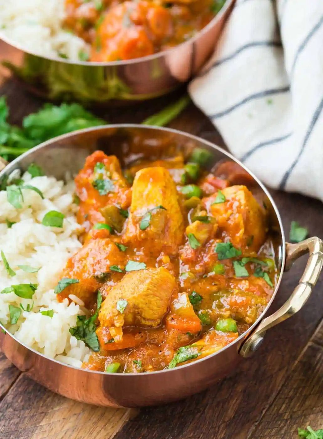 Straightforward tikka masala made with chicken and served with rice in copper bowls.