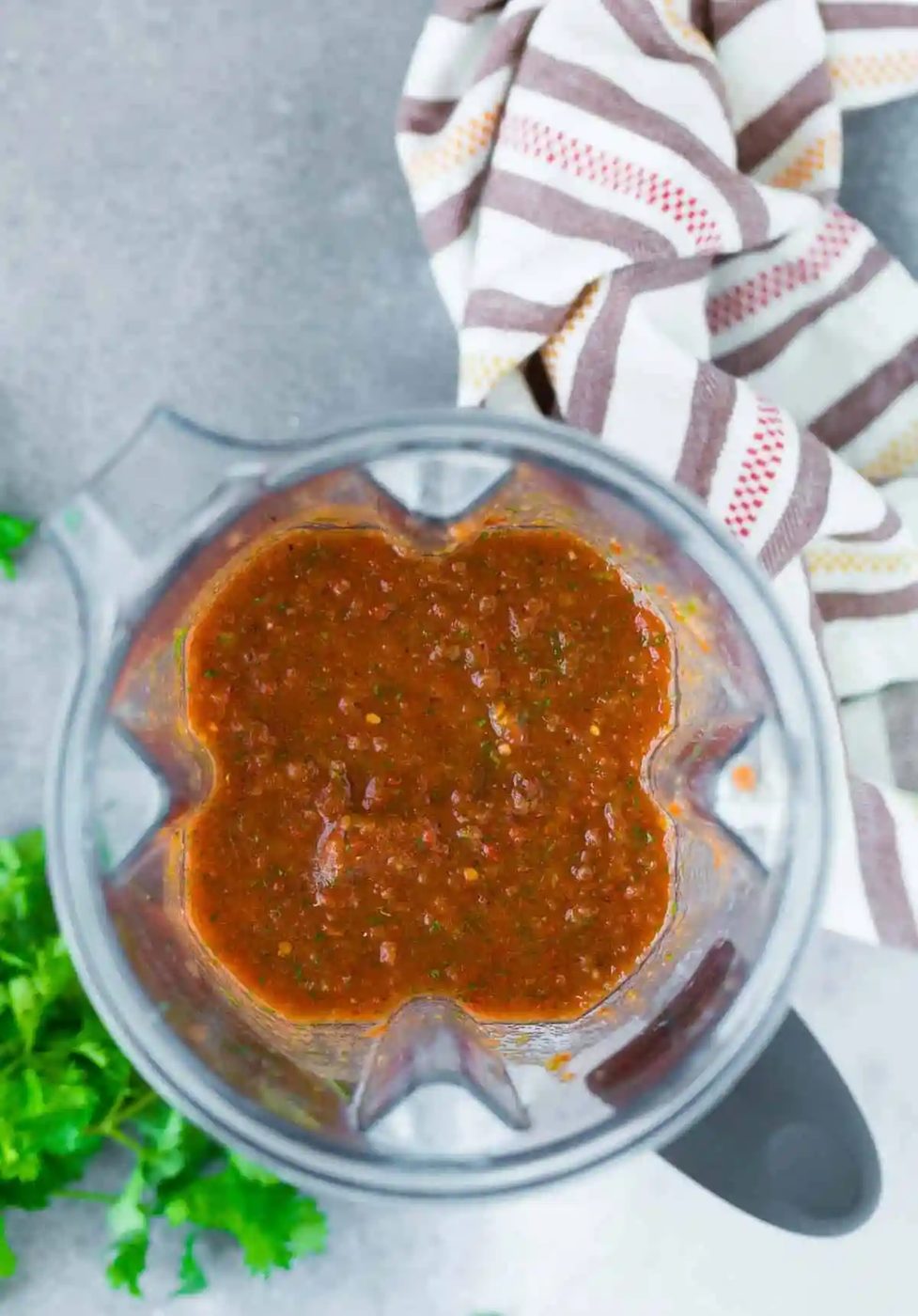 Overhead view of from-scratch salsa in a blender.