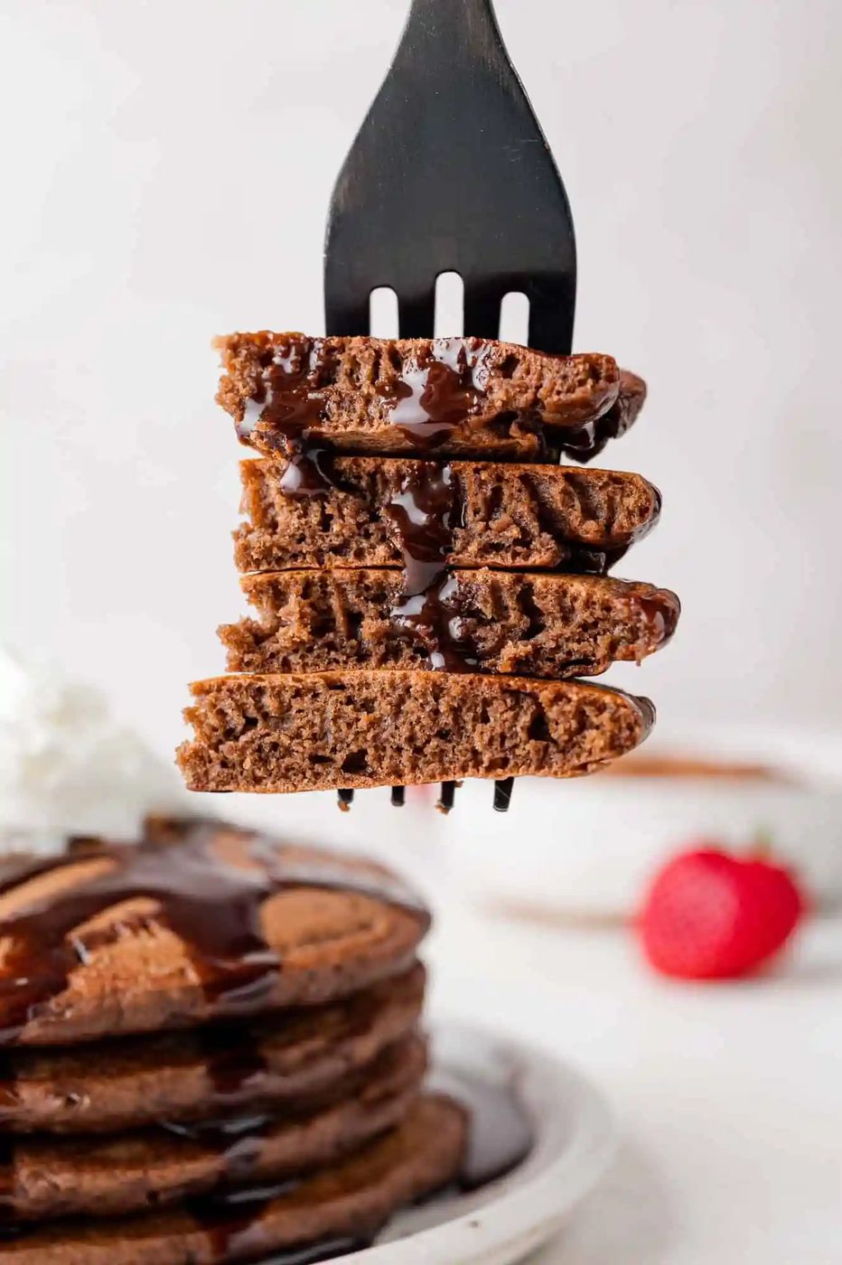 Chocolate pancakes cut and on a fork to show texture.