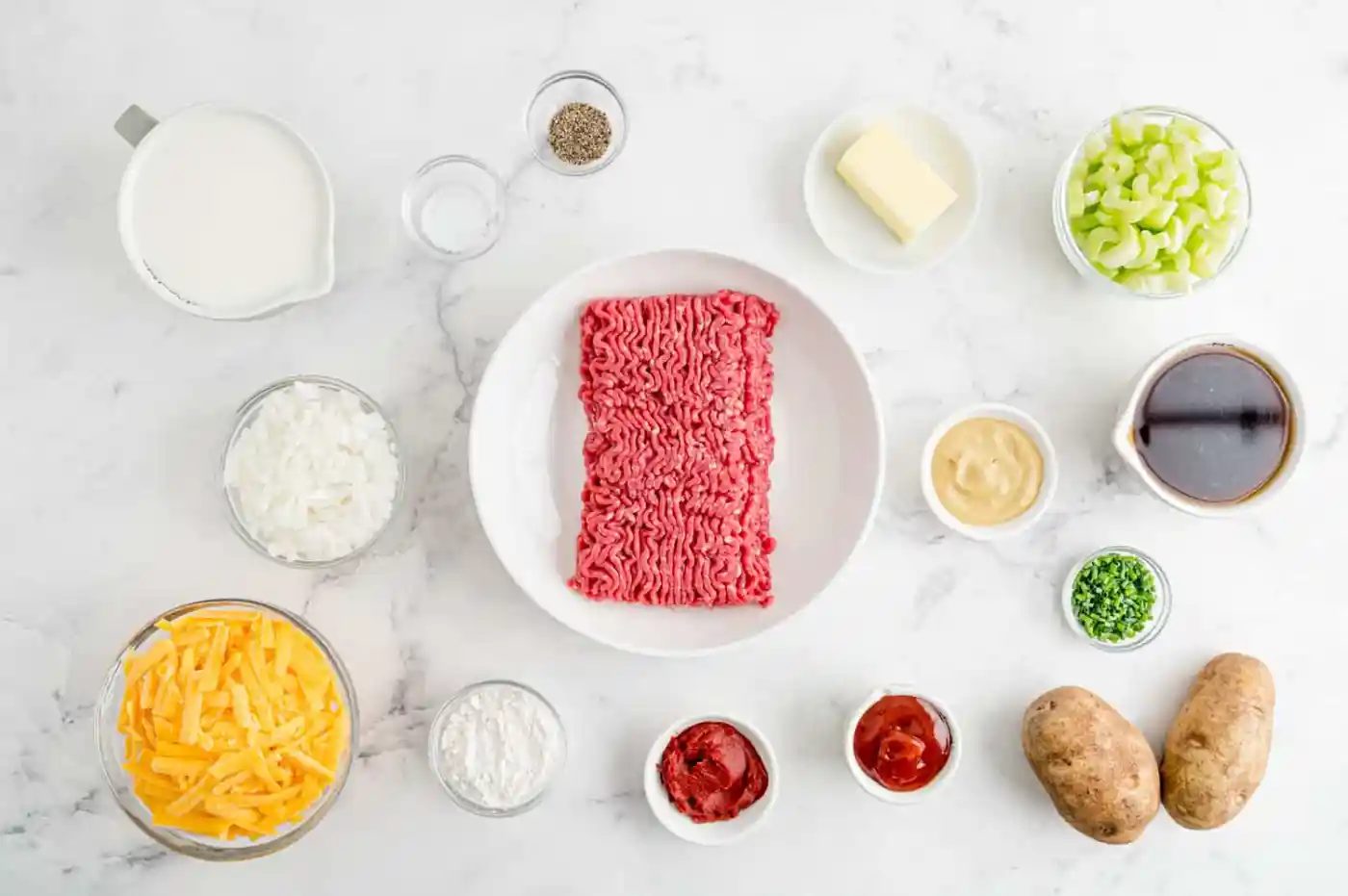 Overhead view of ingredients needed for recipe, all in separate white and clear bowls.
