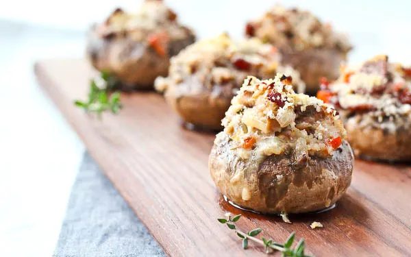 Front closeup of stuffed mushrooms with thyme sprigs.