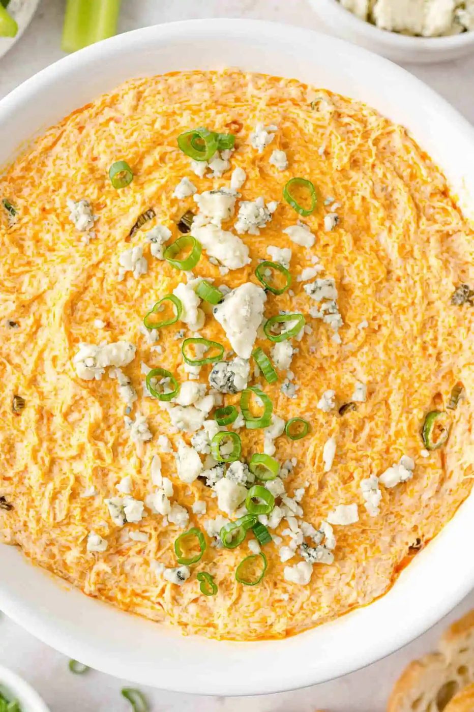 Buffalo chicken dip in a white serving bowl.