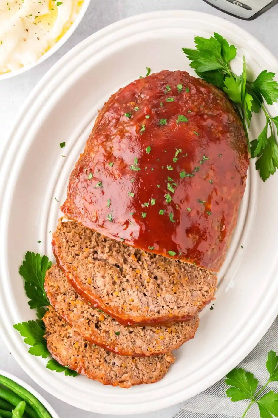 Glazed meatloaf, sliced on a platter.