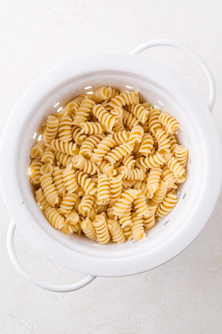 Cooked pasta in colander.