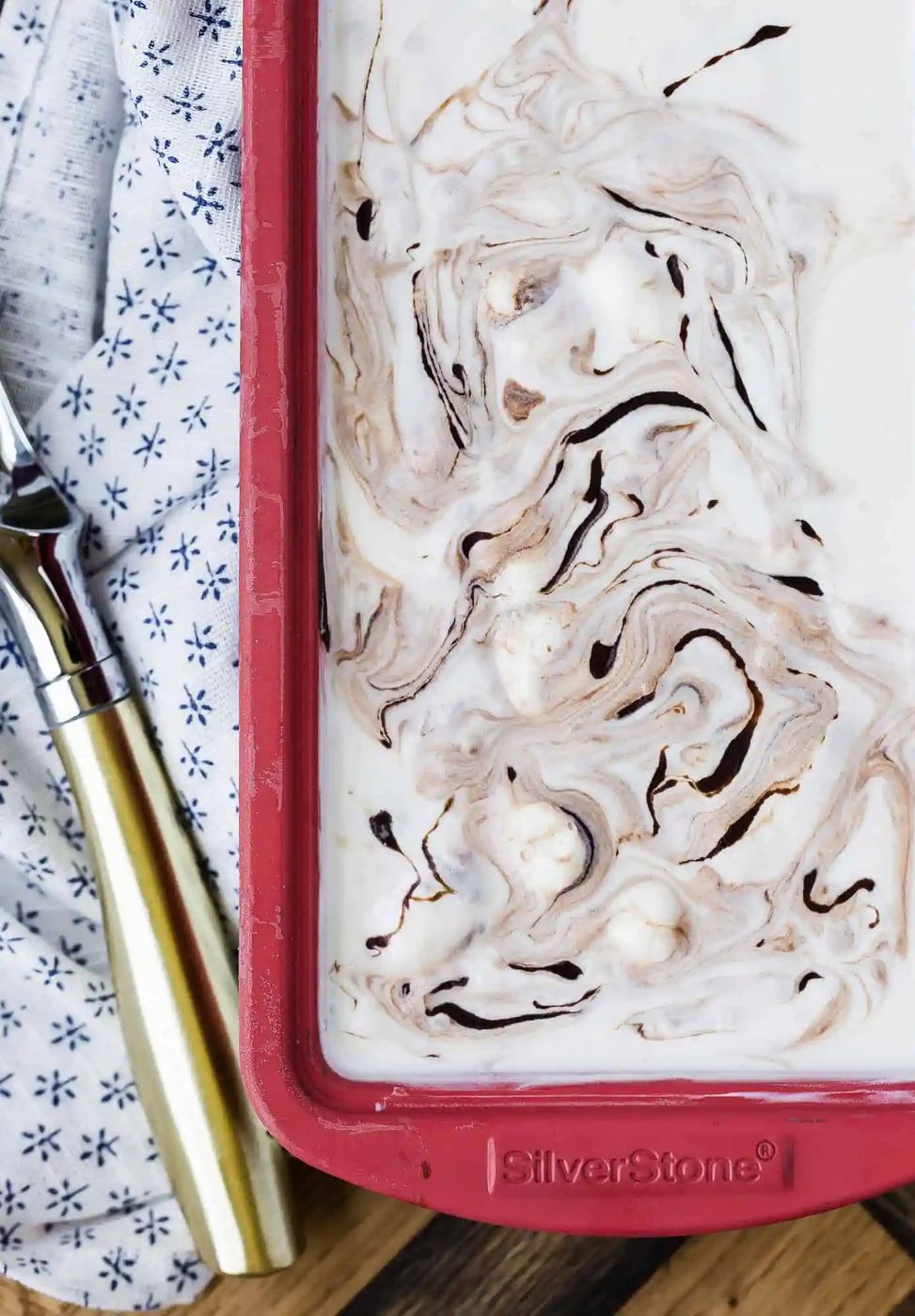 Fudge swirl ice cream in a red loaf pan.