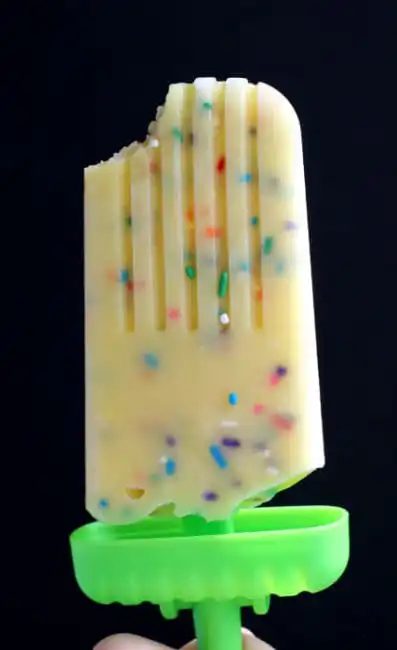 Front view closeup of funfetti pudding pop on black background.