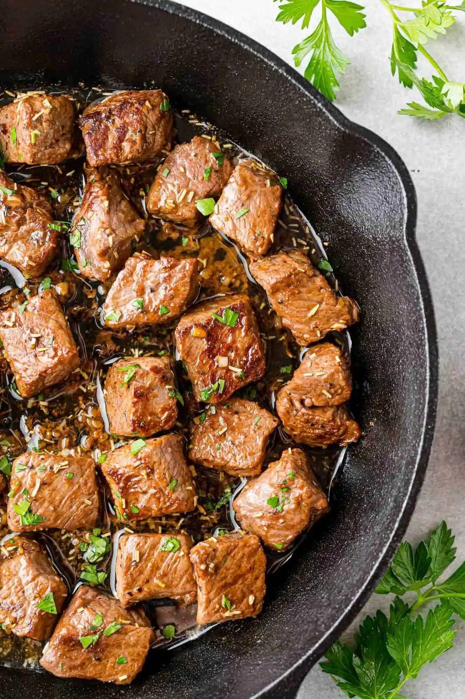 Steak bites in a black skillet.