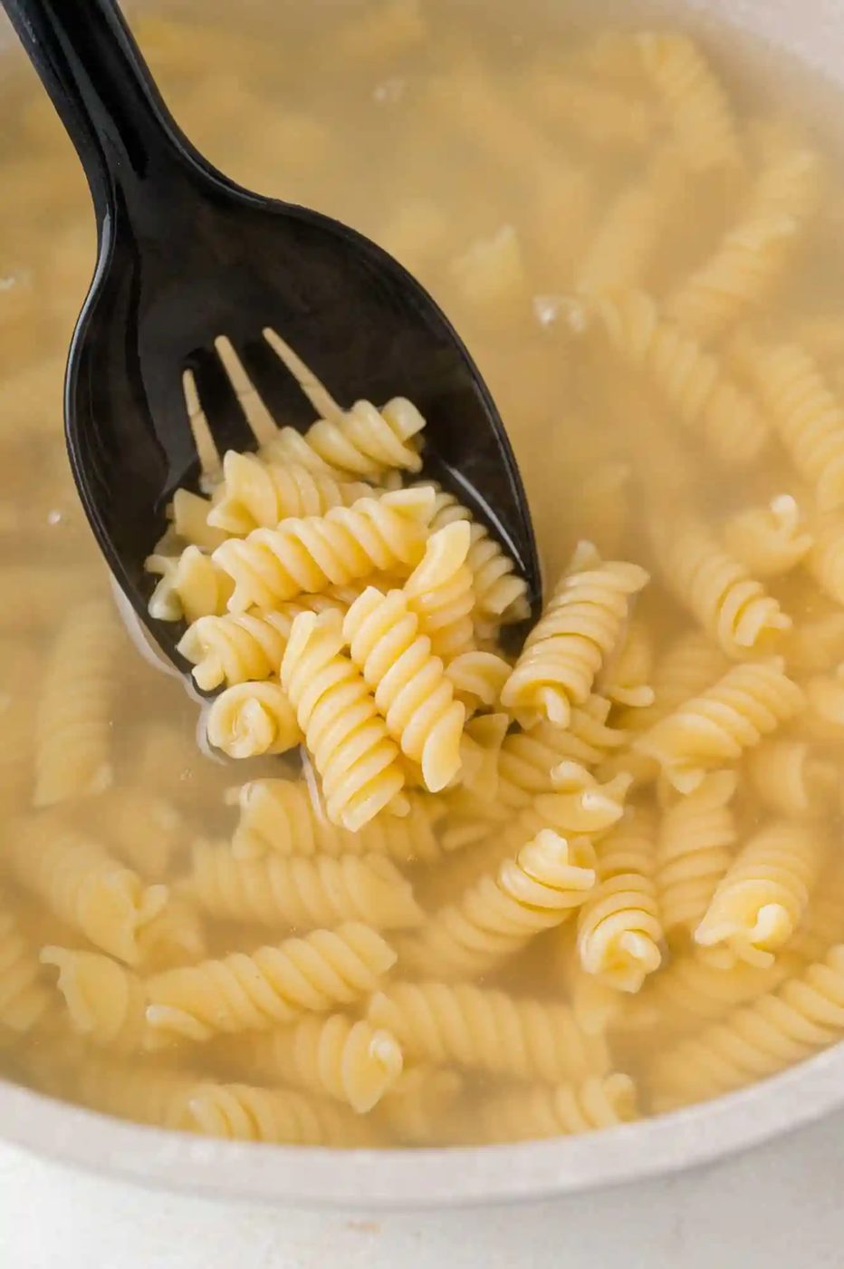 Pasta being cooked in boiling water.