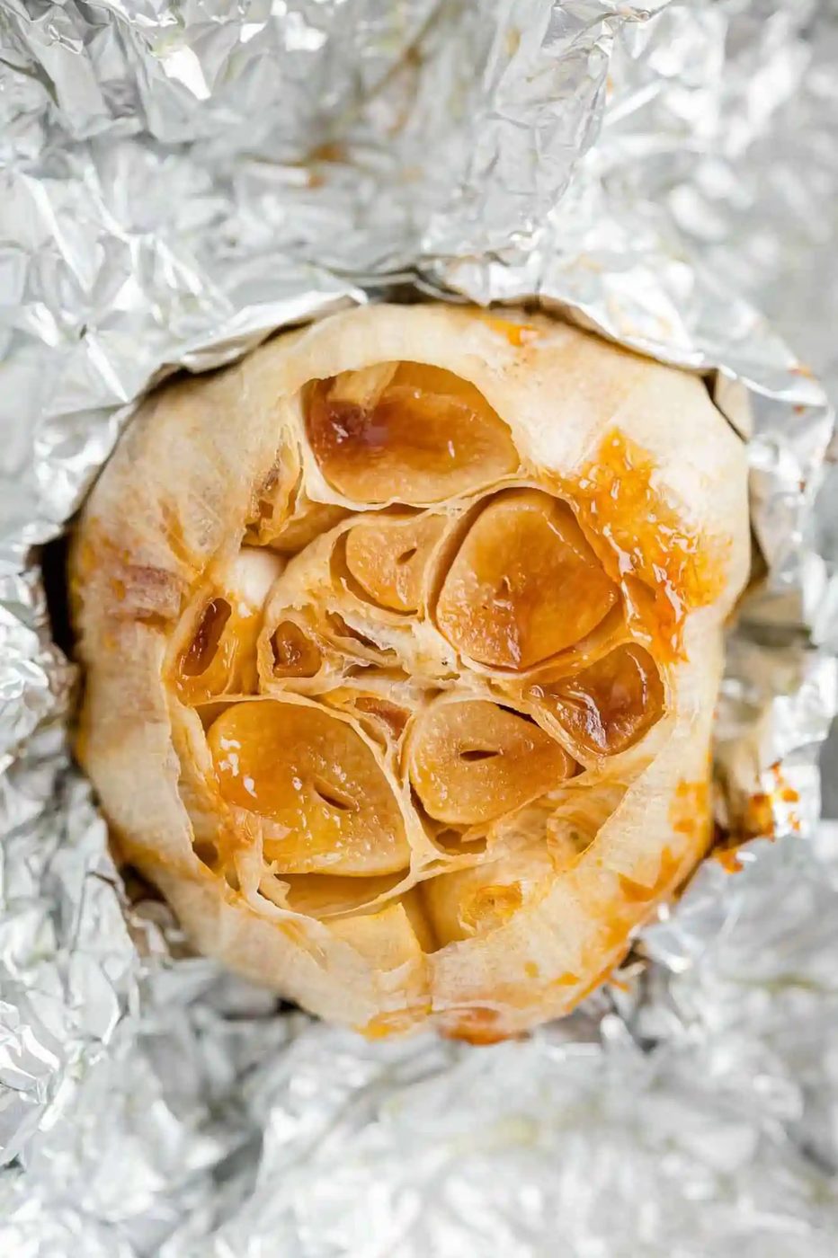 Roasted garlic partially wrapped in foil.