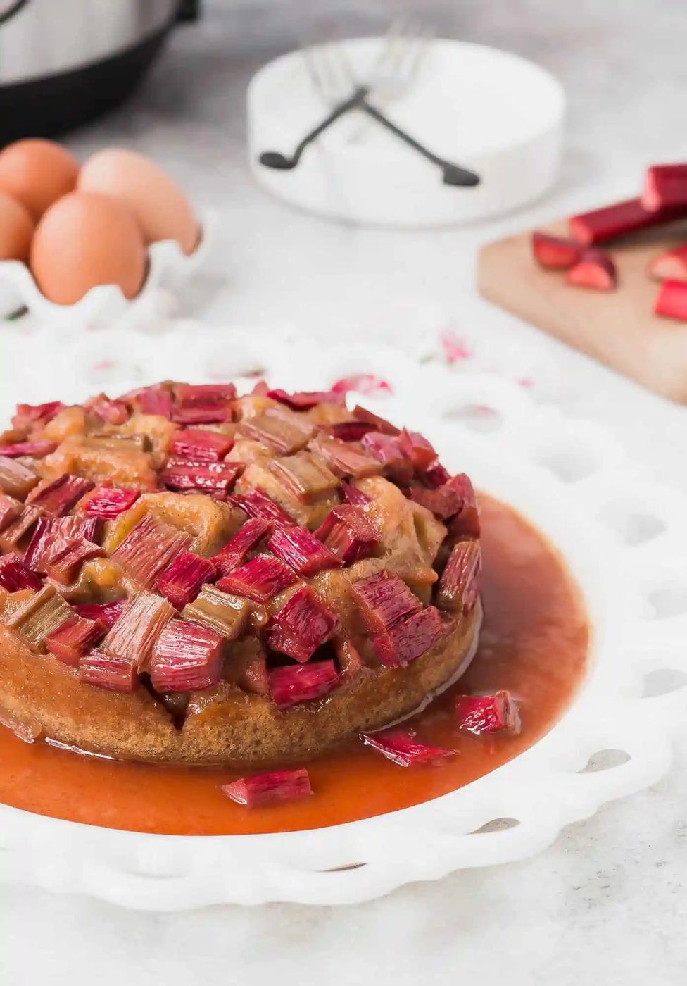 Rhubarb cake in front of eggs, rhubarb, and an Instant Pot.