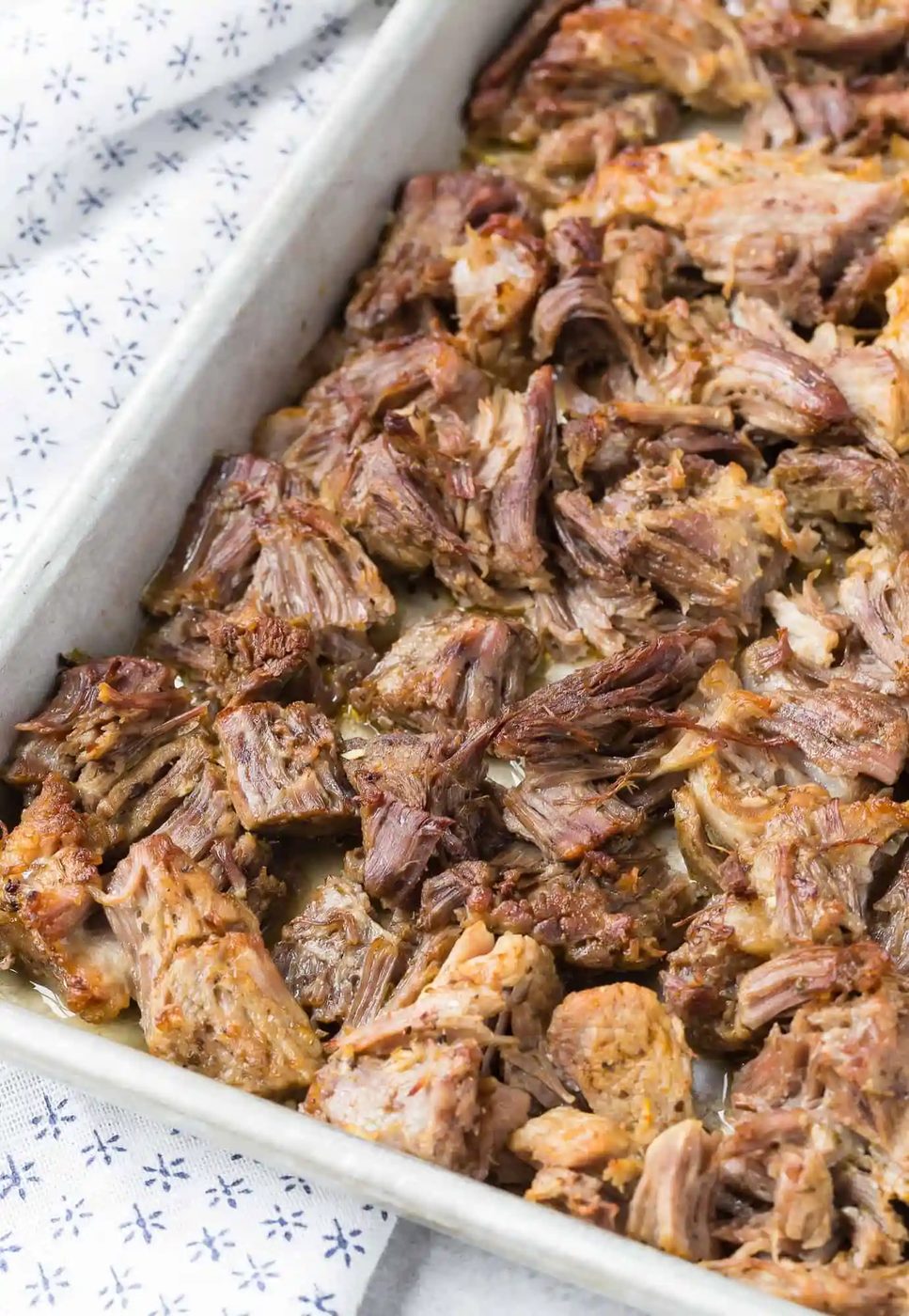 Carnitas, after crisping, on a sheet pan.