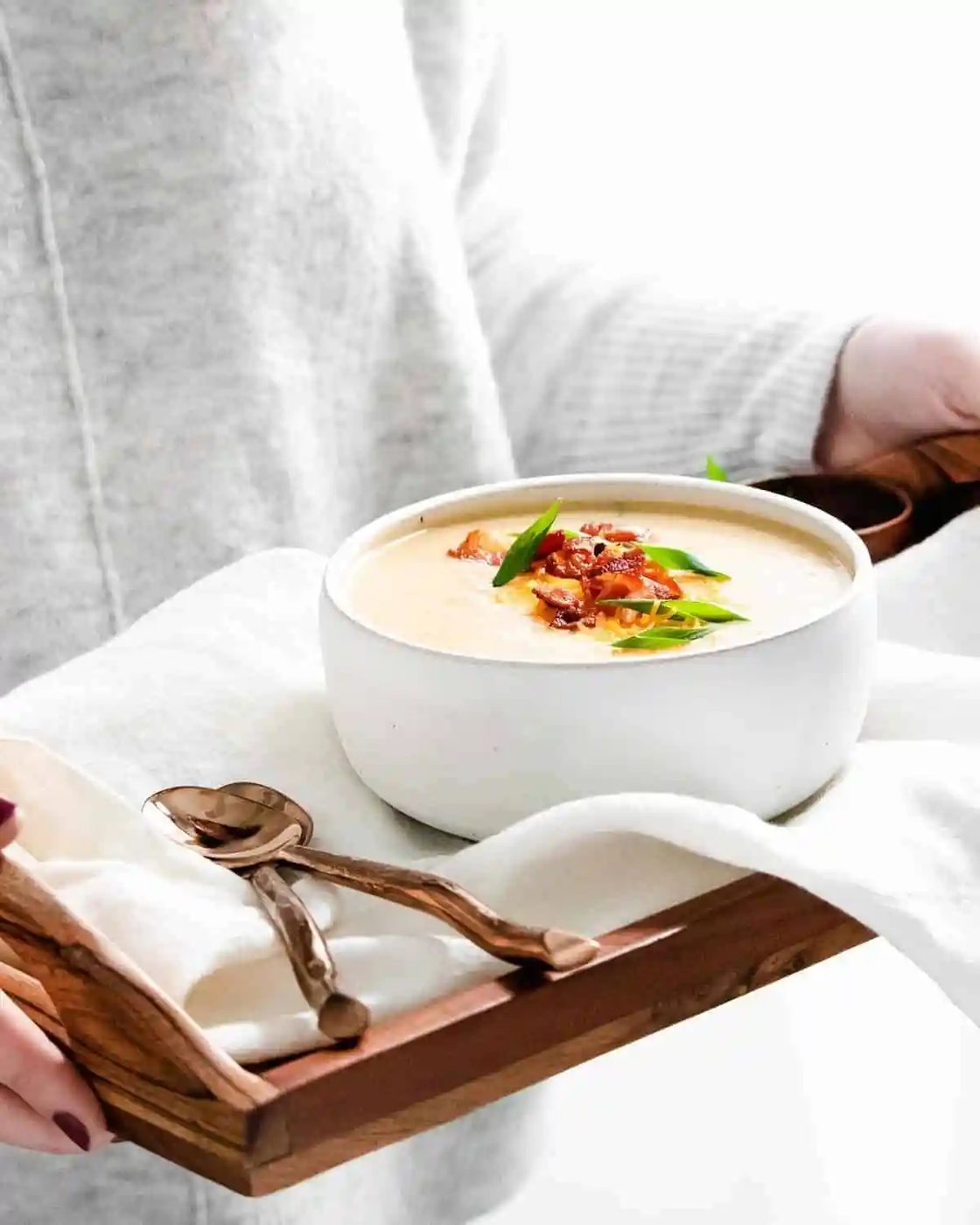 Soup on a tray with spoons.