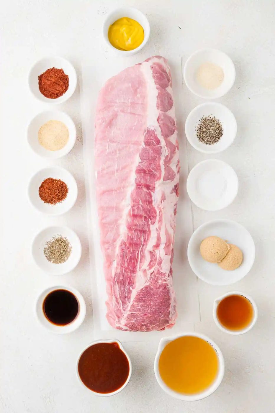 Ingredients needed to make Instant Pot ribs, including a rack of ribs and spices.