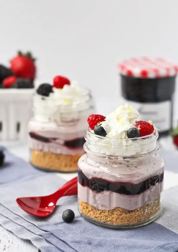Front view of two servings of no bake lemon berry cheesecakes.