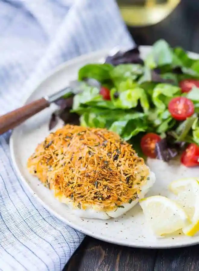 Mild tasting cod encased in a flavorful, crispy crust, this baked cod with lemon and parmesan is a simple and rich way to add lighter seafood to your weekday menu. High in protein and low in fat, inexpensive cod is a great choice.
