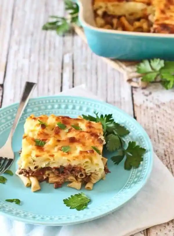 Serving of pastitsio on decorative plate.