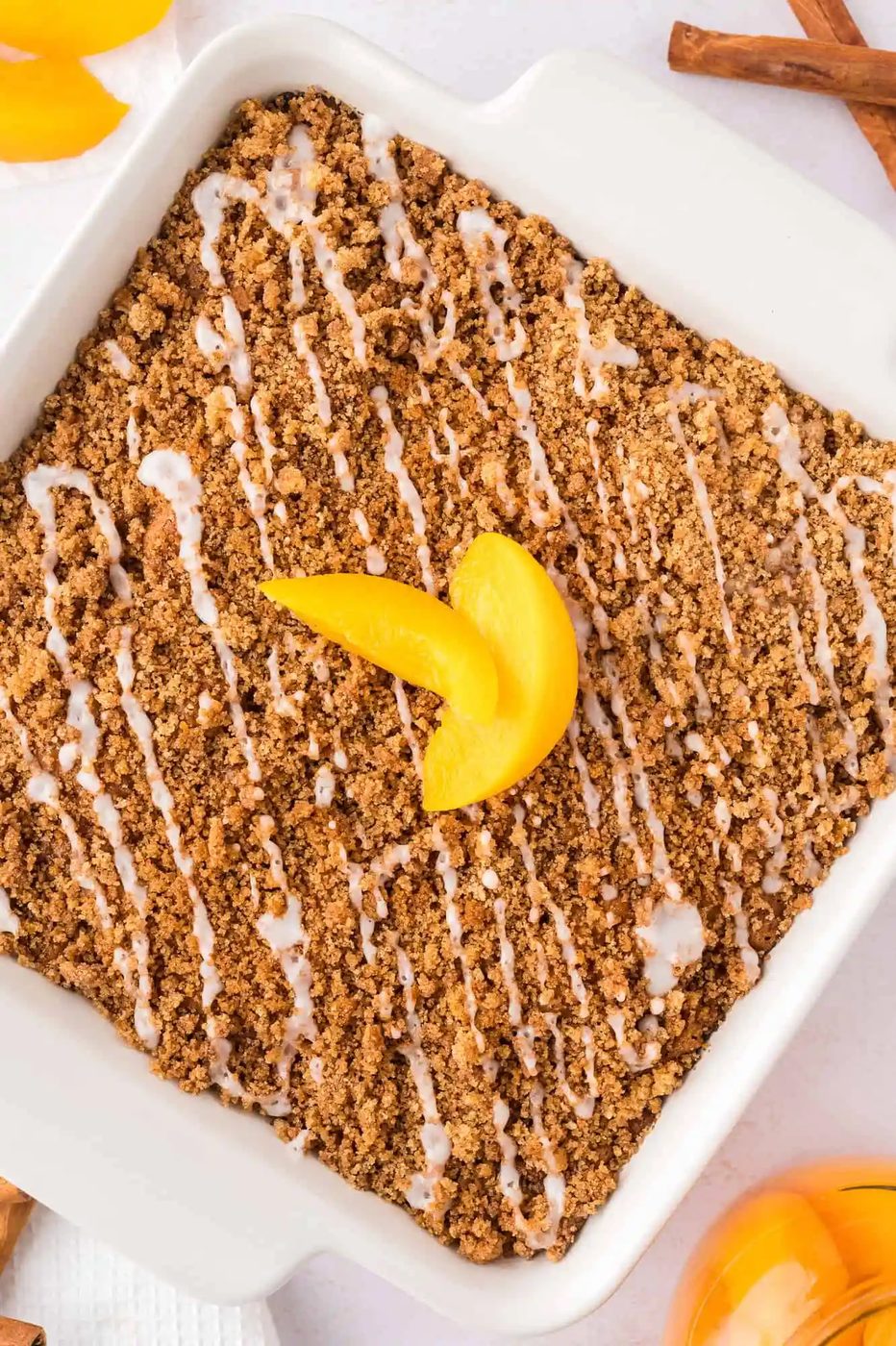 Overhead view of coffee cake topped with sliced peaches.