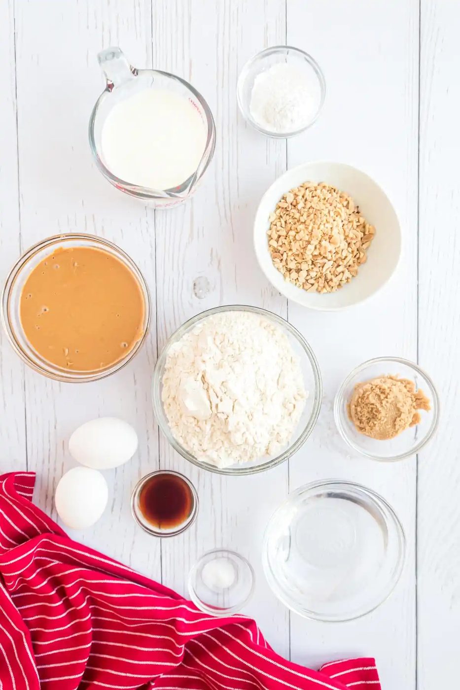 A group of bowls of food on a white surface.
