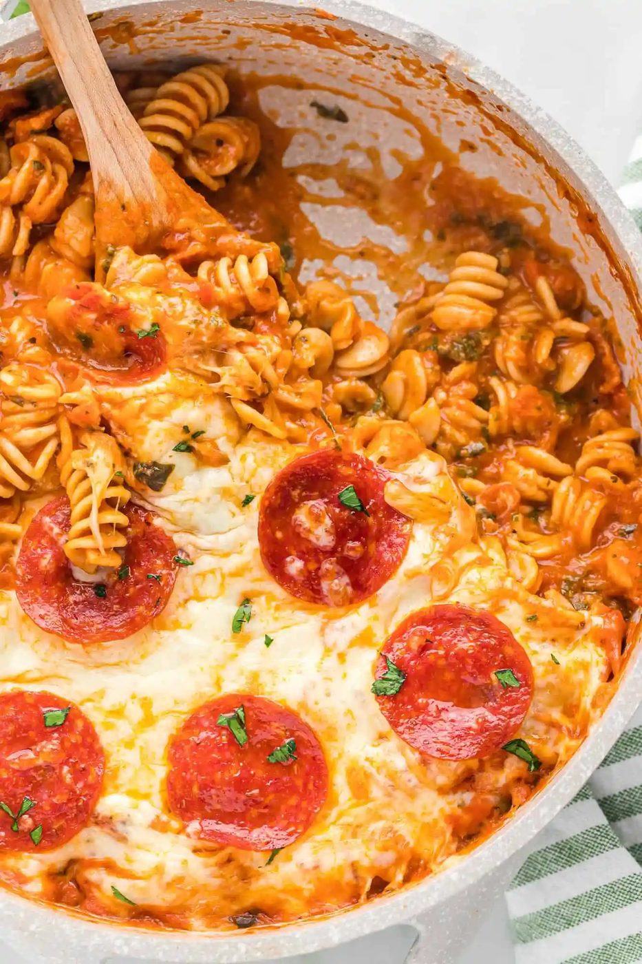 Pizza pasta with some scooped out.