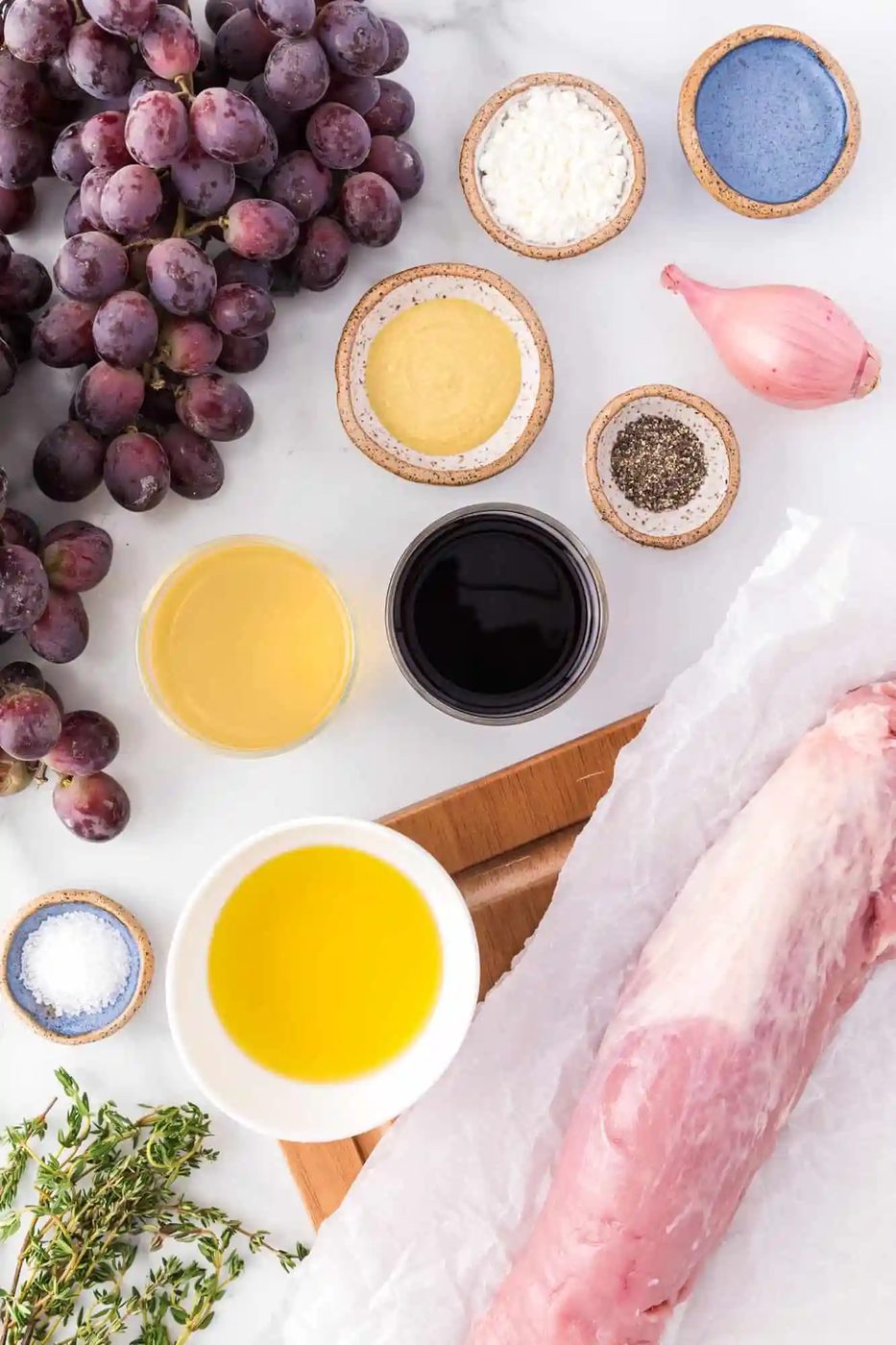 Ingredients needed for recipe including grapes and pork tenderloin.