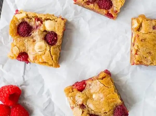 Overhead of blondies on parchment.