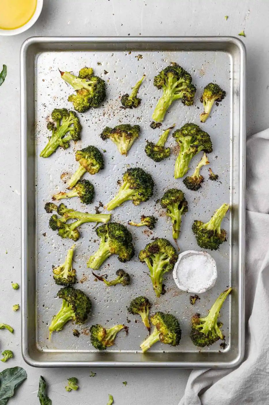 Overhead view of sheetpan full of roasted broccoli.