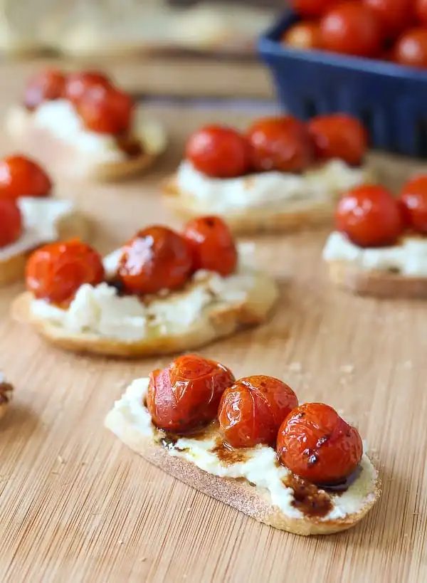 Closeup of crostini on bamboo cutting board.