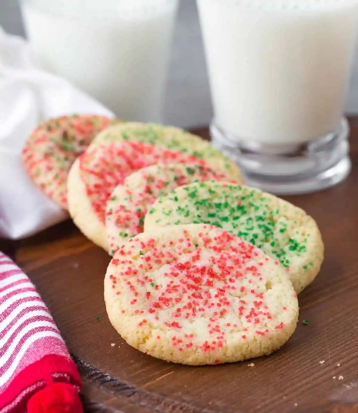 Cookies and milk on a brown wooden tray.