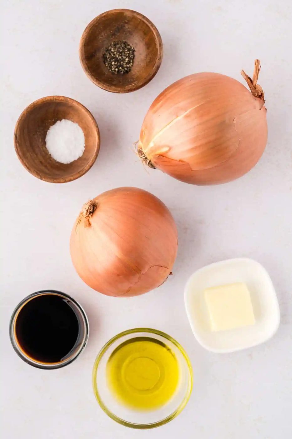 Ingredients needed to make sautéed onions, including two large onions.