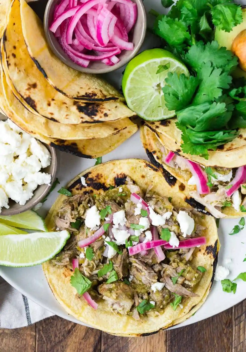 Overhead view of an open pork taco with assorted toppings.