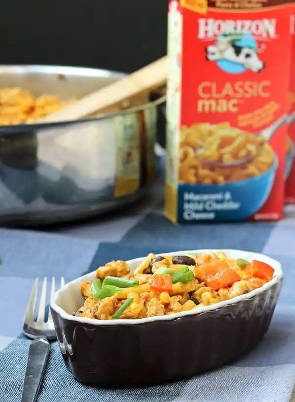 A serving of mac and cheese with pan in background, also box of Horizon Classic Mac and Cheese.