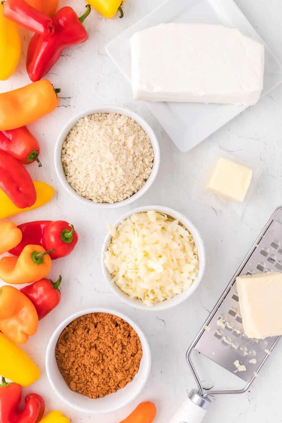 Ingredients needed for mini stuffed peppers, including colorful mini sweet peppers.