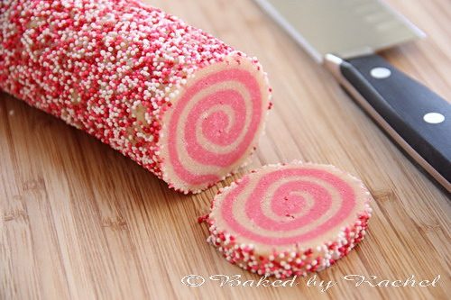 A log of cookie dough being cut into slices.