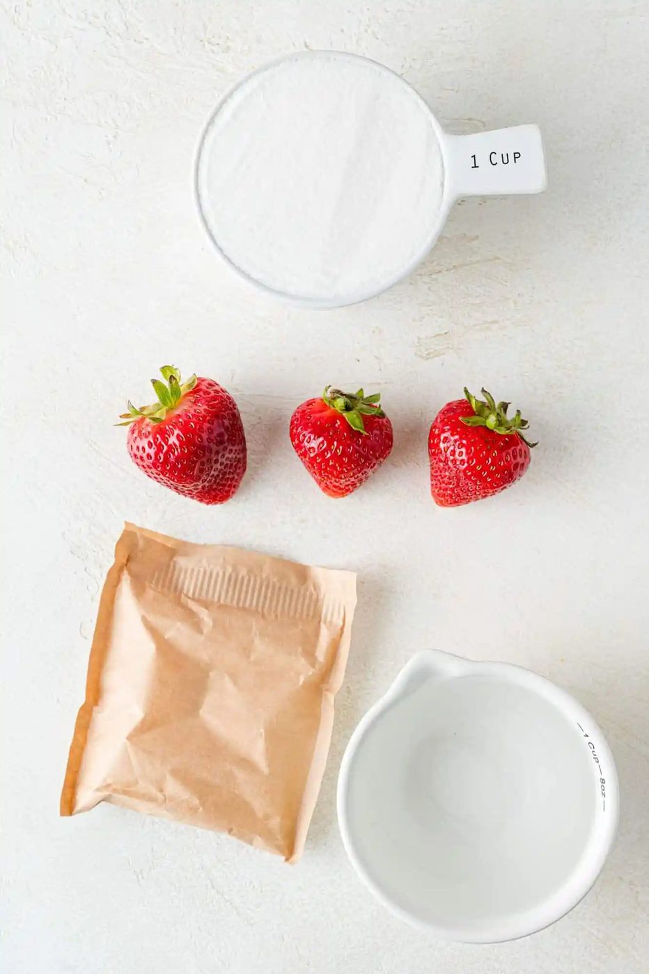 Ingredients needed to make strawberry freezer jam.