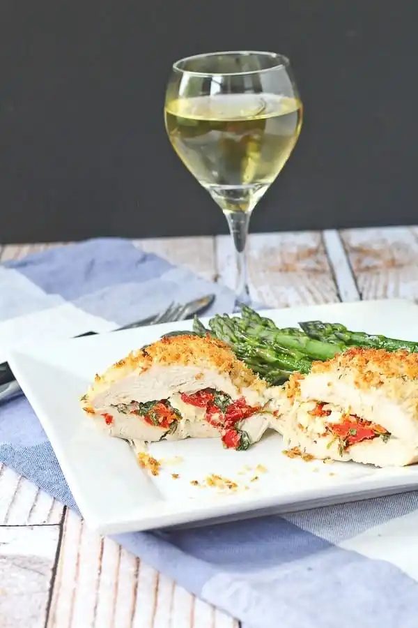 Feta Stuffed Chicken Breasts, served with Sun-Dried Tomato and Kale