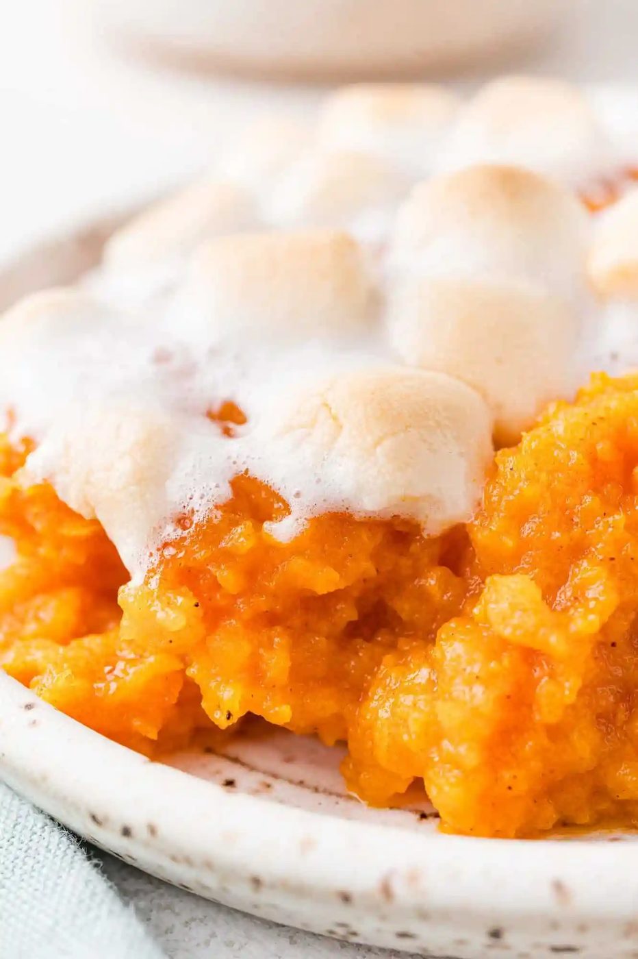 Sweet potato casserole with marshmallows, on a plate.