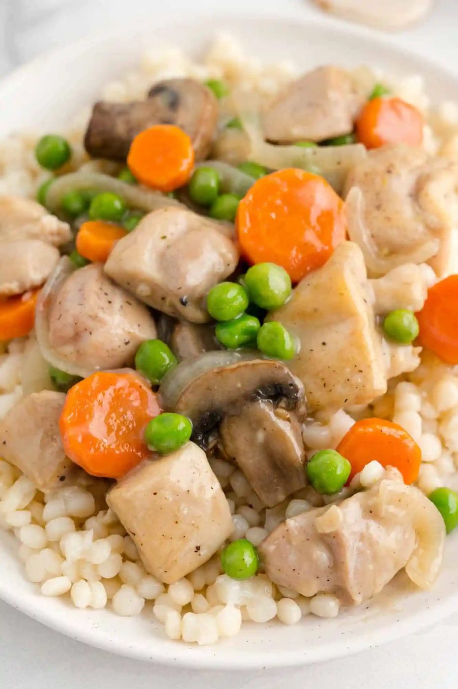 Vegetables and chicken served over pearl couscous.