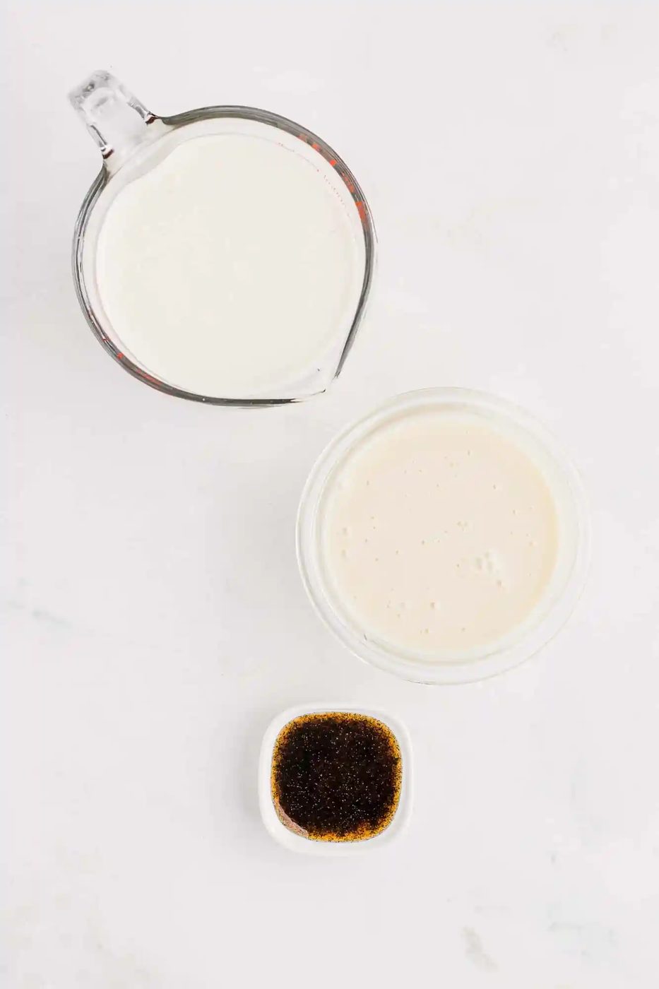 Overhead view of the three ingredients needed to make from-scratch vanilla ice cream.
