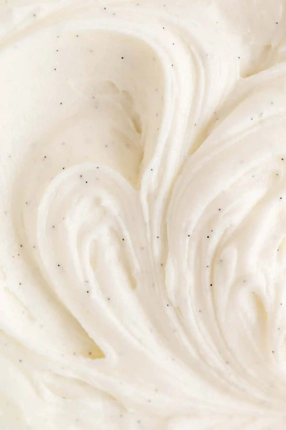 Close up of vanilla buttercream frosting with real vanilla seeds.
