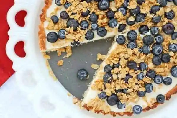 Partial overhead image of tart with one slice removed.