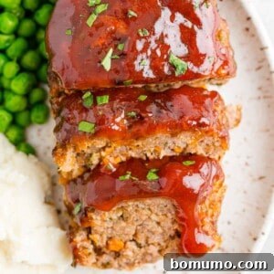 Air fryer meatloaf, perfectly sliced and served with accompanying side dishes.