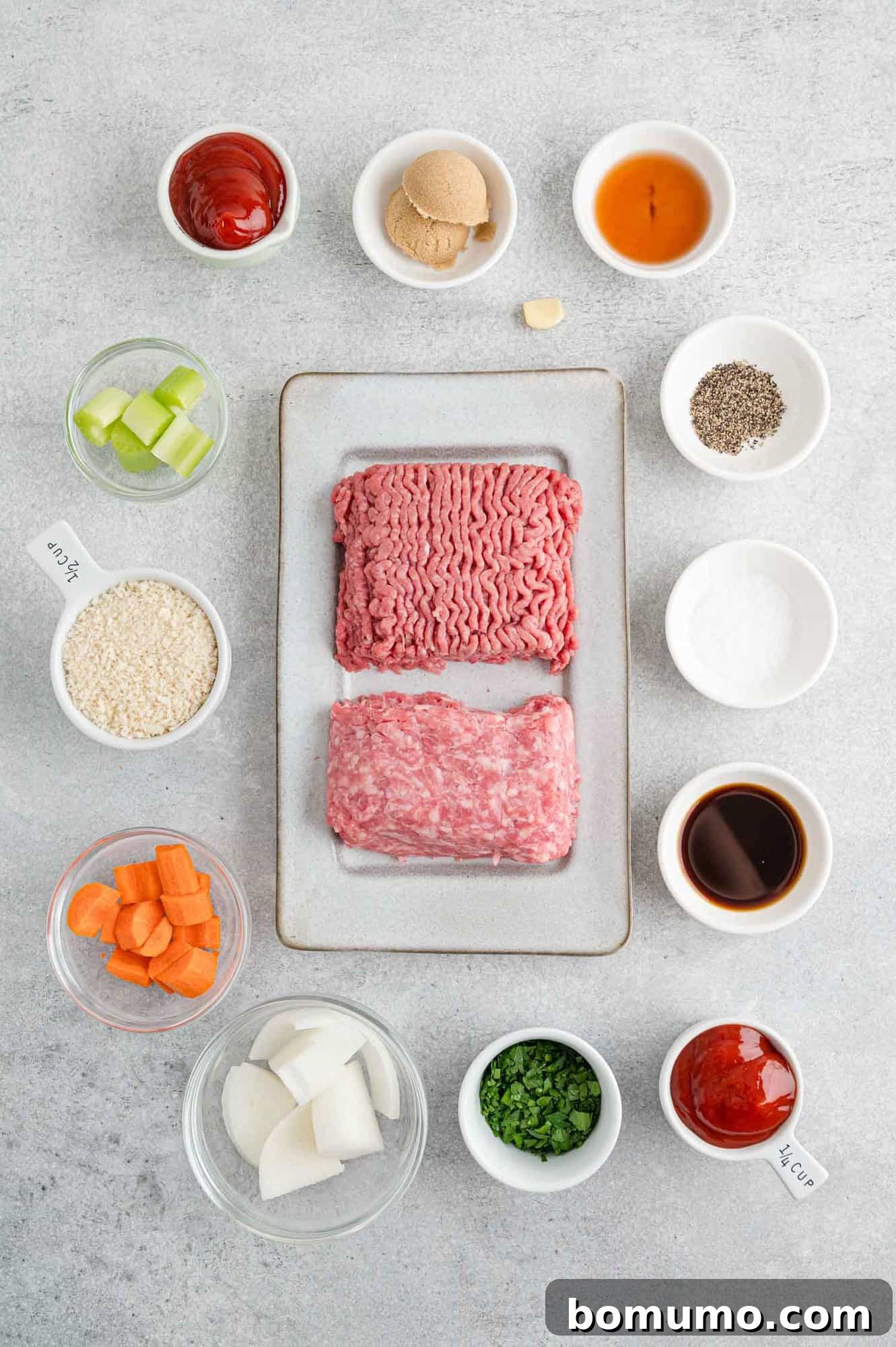 All the fresh ingredients laid out for the air fryer meatloaf recipe, including ground beef, pork, fresh vegetables, and seasonings.
