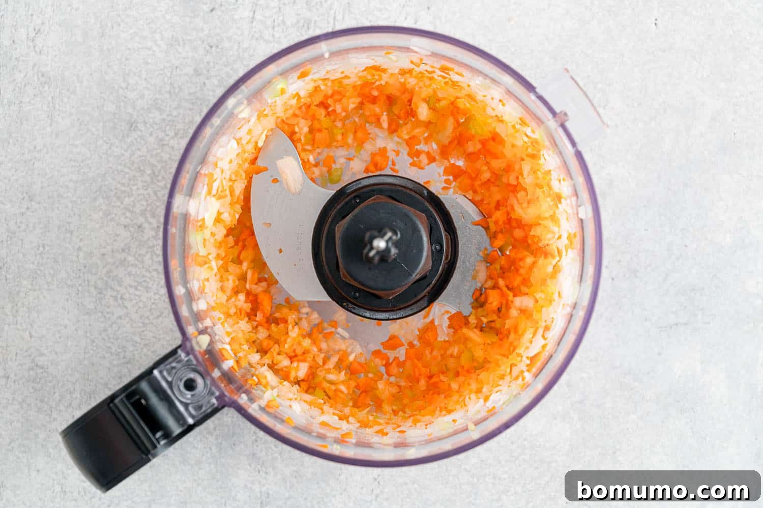 Finely minced carrots, onions, and celery after processing, demonstrating the ideal texture for meatloaf.